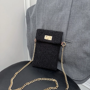 Black plush crossbody phone bag with gold chain strap and metal swivel lock