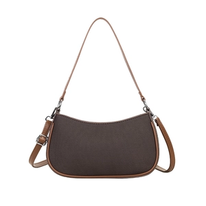 Brown fabric crescent underarm bag with leather trim and silver hardware on white background