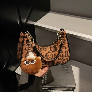 Vintage leopard print suede handbag with gold chain strap and plush charm accessory