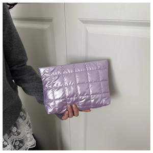 Close-up of lavender quilted puffer clutch bag with metallic finish and box stitching