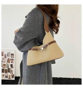 Detail of vintage suede tote bag with brown shoulder strap and golden metal buckle
