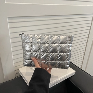Metallic silver quilted handbag featuring a large capacity design and black zipper closure