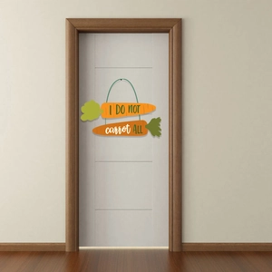 Easter home decor sign with two orange carrots and I DO NOT carrot ALL text on white door