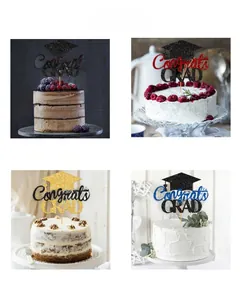 Close-up of glittery Congrats GRAD cake toppers with mortarboard designs for graduation