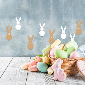 Easter rabbit paper ornaments in white and kraft colors with festive bows and hanging strings