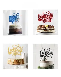 Detail view of Congrats Grad glitter cake toppers in blue, red, gold and black finishes