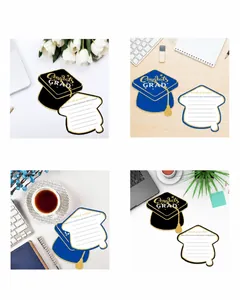 Close-up of graduation cap cards with words of wisdom on a desktop background