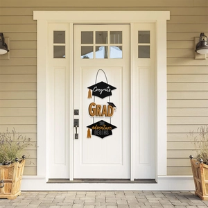 Class of 2026 graduation door sign with black and gold grad cap hanging ornaments