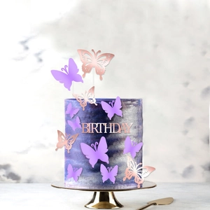 Detail showing 3D rose gold and purple butterfly cake toppers with Birthday signage