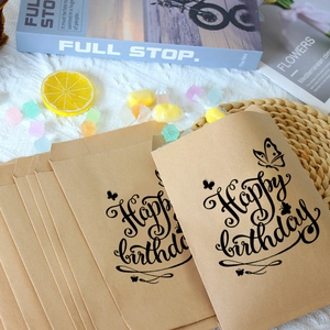 Macro detail of kraft paper gift bags featuring butterfly prints and Happy Birthday text