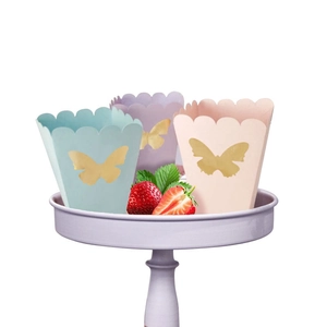 Pastel macaron popcorn boxes with golden butterflies on a lavender cake stand