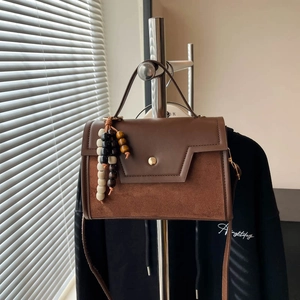 Vintage brown leather and suede baguette bag with wooden beads and gold metallic clasp