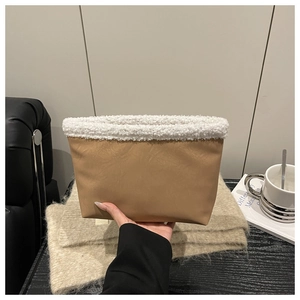 Detail of warm brown PU leather handbag with white plush fleece trim and trapezoid design