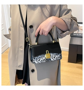 Detail of grey leopard print and black leather bag with gold square padlock buckle