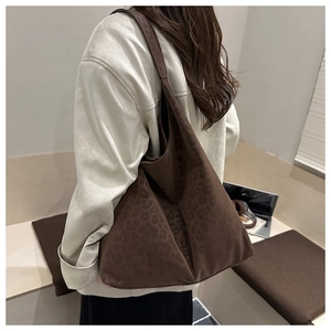 Side view of a deep brown leopard print tote bag with premium matte suede texture