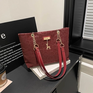 Retro burgundy leopard embossed tote bag with gold chain and deer pendant detail