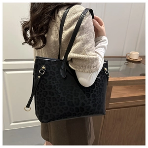 Detail of leopard print tote bag with matte texture and metallic ring buckle on model