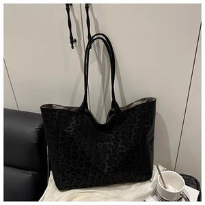 Detail view of large tote bag with subtle dark leopard print and slim black shoulder straps