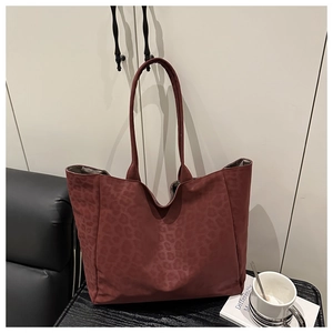 Detail of burgundy leopard print tote bag showing soft texture and large capacity