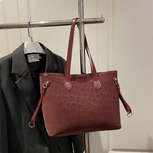 Deep wine red leopard print tote bag in frosted texture with smooth leather trim