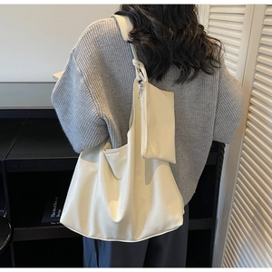 Detailed view of cream white leather tote with matching small zipper coin purse