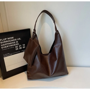 Detail of vintage coffee brown tote bag featuring knotted strap and hanging coin purse