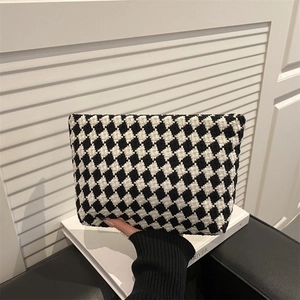 Handheld vintage black and white houndstooth knit pouch with woven texture and soft design
