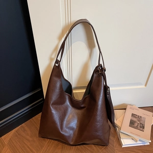 Dark brown high-capacity faux leather tote bag with matching coin pouch on wood floor