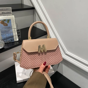 Pink leather and woven herringbone shoulder bag with gold M-logo and top handle