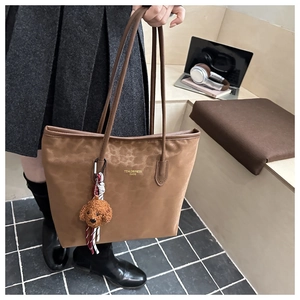 Brown faux leather tote bag with subtle leopard print and cute plush puppy charm
