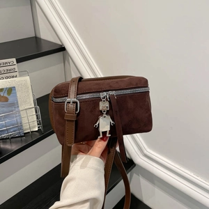 Suede brown crossbody box bag with metal robot pendant and silver zipper detail