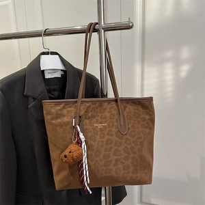 Brown leopard print tote bag with plush bear charm and leather straps for autumn winter