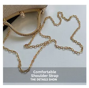 Detail of comfortable golden metal chain strap on a sparkling champagne evening clutch
