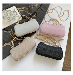 Detailed view of sparkly evening clutches with elegant pearl clasps and golden chains