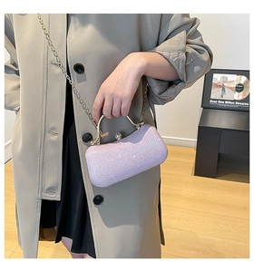 Detailed view of lavender sequin evening clutch with golden handle and chain strap