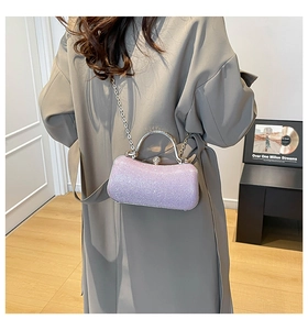 Detail of light purple sequin evening clutch bag with silver metal handle and chain strap