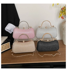 Detail view of textured glitter clutch bags with pearl clasps in four elegant colors