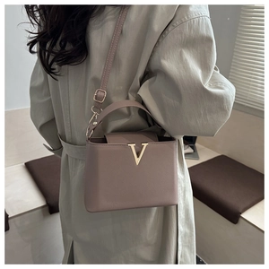 Litchi pattern leather crossbody bag with gold V-shaped logo and adjustable strap