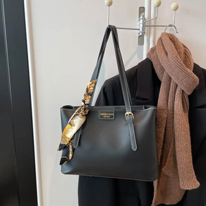 Large black soft leather tote bag with printed silk scarf detail for office commute
