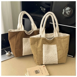 Detail of contrast stitch suede tote bags with fleece trim in a cozy workspace setting