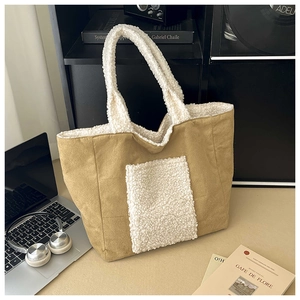 Detail of faux suede tote bag with white plush trim and large front furry pocket