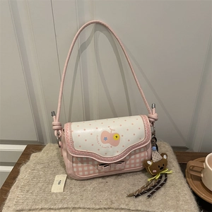 Pink and white shoulder bag with wave patterns, polka dots, and bear plush charm