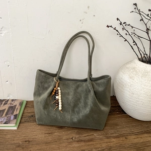 Vintage dark green faux suede tote bag with fringe bead charm and retro aesthetic style