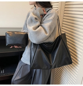 Chic black faux leather tote bag set with matching inner pouch shown on model