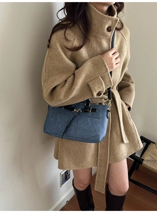 Blue denim texture small square bag with strap detail shown on a wool coat outfit