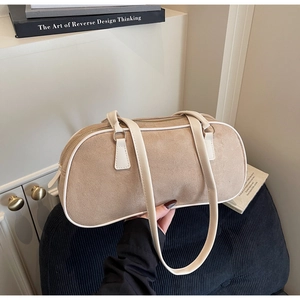 Detail of suede bowling bag with contrast stitching and metal zipper for daily use