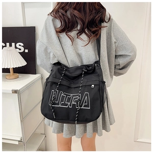 Close-up of black mesh messenger bag with LITRA print and side net pocket detail
