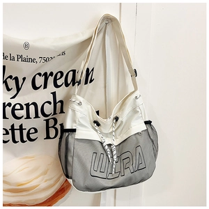 Detail of canvas tote bag with WERA lettering, drawstring closure and mesh side pocket