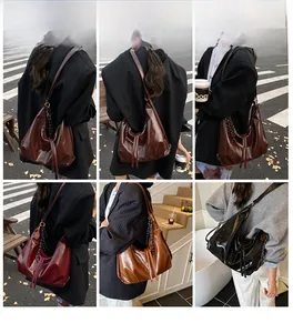 Chic Hobo shoulder bag with braided straps and fringe tassels shown in urban street style