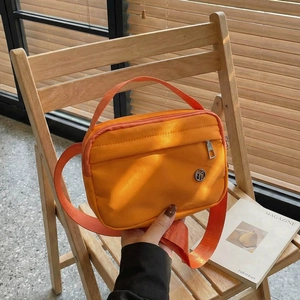 Sac à bandoulière minimaliste en nylon orange vif avec large sangle et poignée
